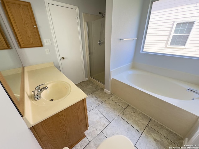 bathroom with plus walk in shower, vanity, and tile patterned floors