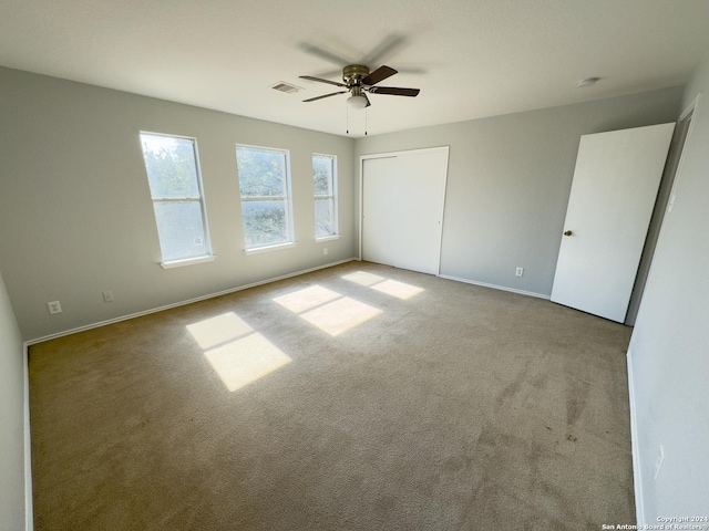 unfurnished bedroom featuring ceiling fan and light carpet