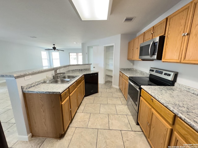 kitchen with appliances with stainless steel finishes, light tile patterned floors, ceiling fan, and sink