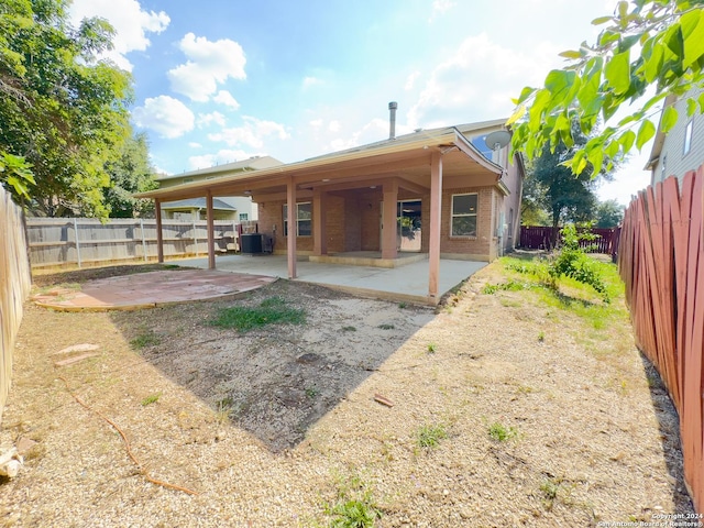 rear view of property featuring a patio and cooling unit