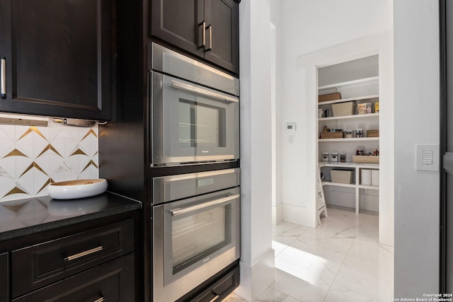 kitchen featuring backsplash and stainless steel double oven