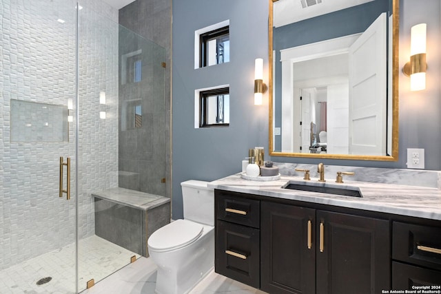 bathroom featuring vanity, toilet, and an enclosed shower