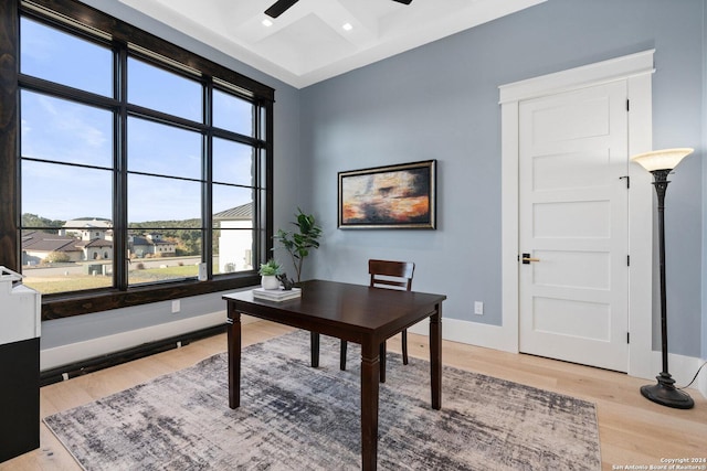 office area with plenty of natural light, light hardwood / wood-style floors, and ceiling fan