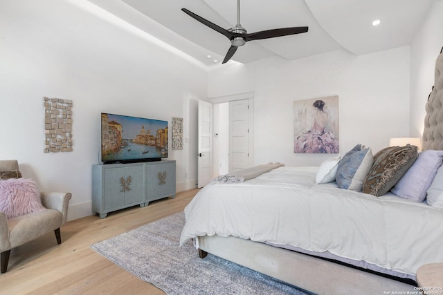 bedroom with light hardwood / wood-style flooring and ceiling fan