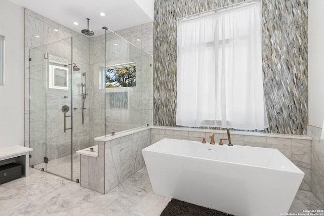 bathroom featuring separate shower and tub and tile walls