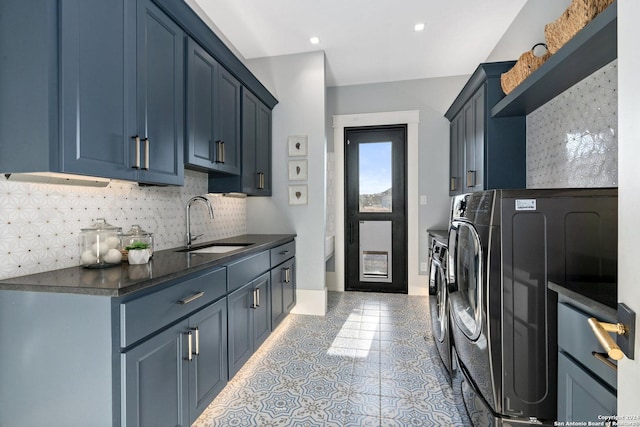 laundry room featuring cabinets, sink, and washing machine and clothes dryer