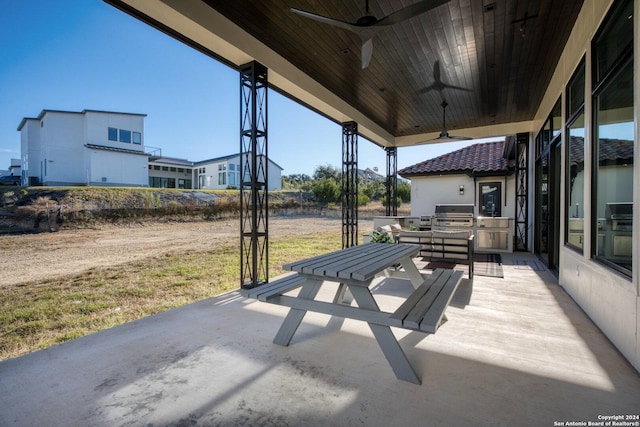 view of patio with ceiling fan, a grill, and exterior kitchen