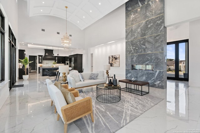 living room with a premium fireplace, high vaulted ceiling, and french doors