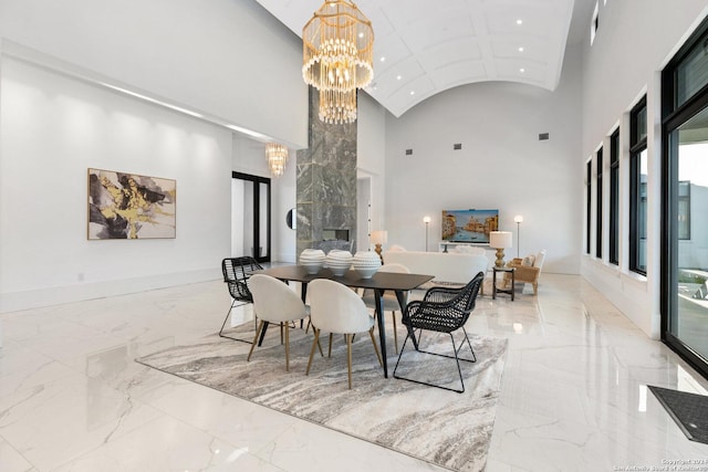 dining room featuring a chandelier and high vaulted ceiling