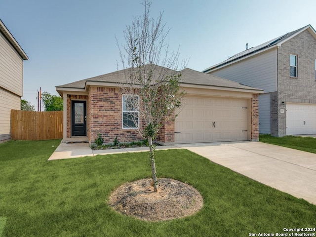 view of front of property with a front yard and a garage