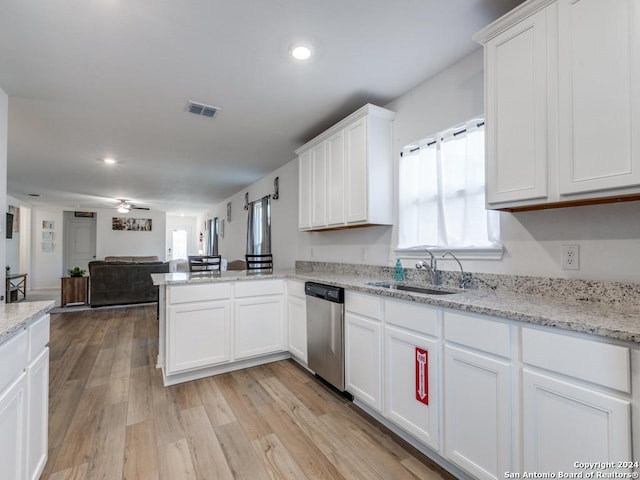 kitchen featuring light hardwood / wood-style flooring, stainless steel dishwasher, a wealth of natural light, and sink