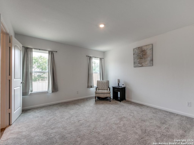 unfurnished room featuring light colored carpet