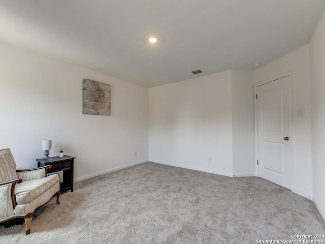 unfurnished room featuring light carpet