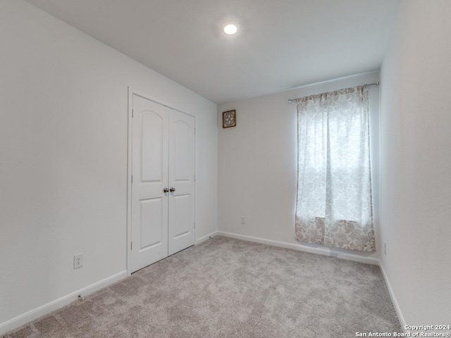 unfurnished room with light colored carpet