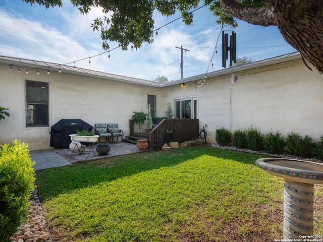 back of house with a yard and a patio area