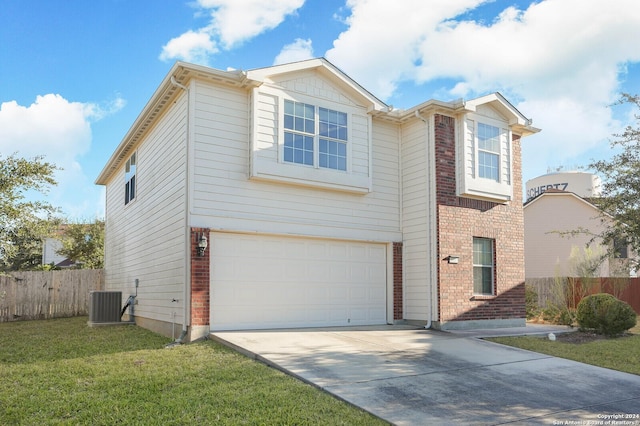 view of front facade featuring cooling unit, a garage, and a front lawn