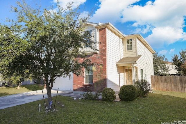 view of front of home with a garage and a front lawn