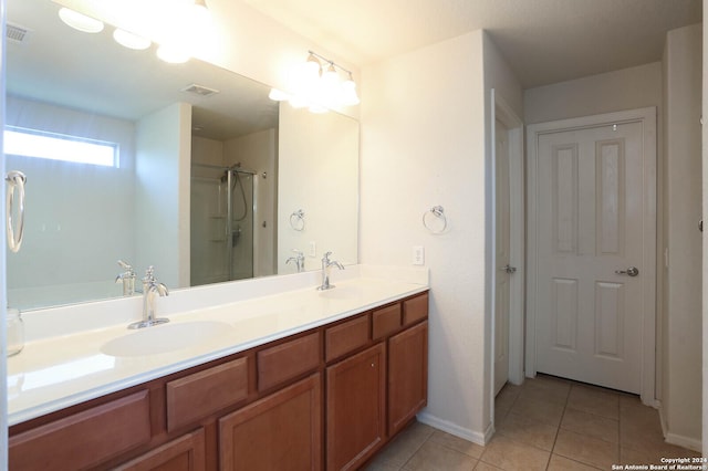 bathroom featuring tile patterned flooring, vanity, and a shower with door