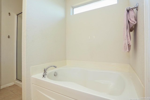 bathroom with tile patterned flooring and independent shower and bath