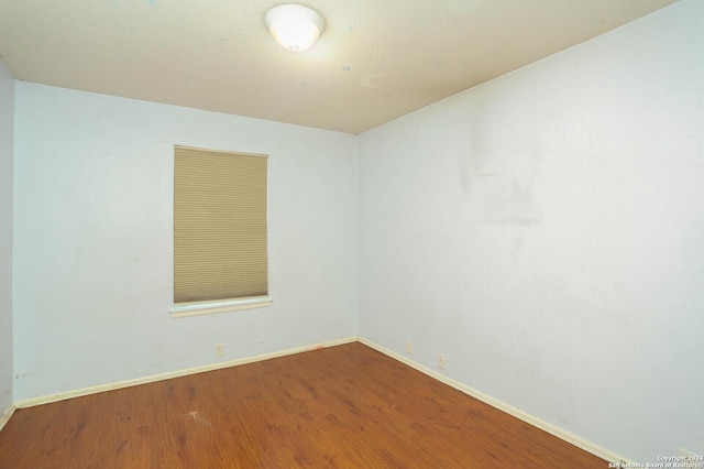 unfurnished room featuring hardwood / wood-style flooring