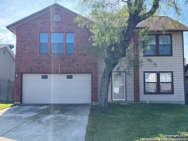 view of front of home with a garage and a front yard