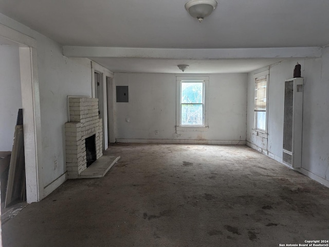 unfurnished living room featuring electric panel, light carpet, and a brick fireplace