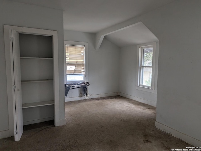 bonus room featuring carpet flooring, vaulted ceiling, and plenty of natural light