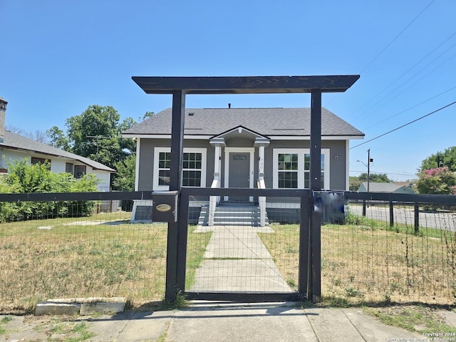 view of front of house with a front lawn and central air condition unit