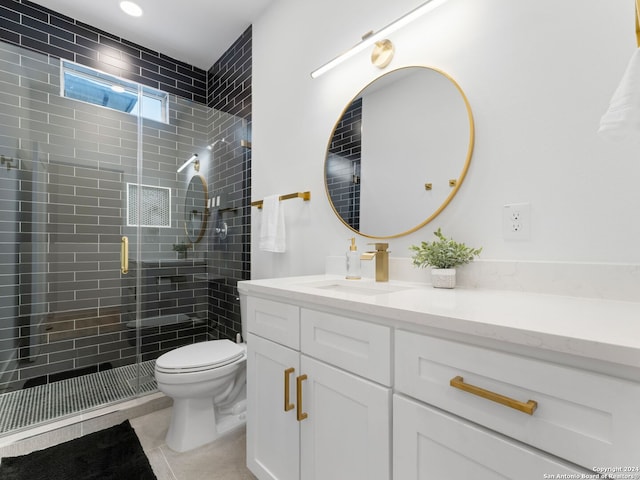 bathroom featuring tile patterned flooring, vanity, an enclosed shower, and toilet