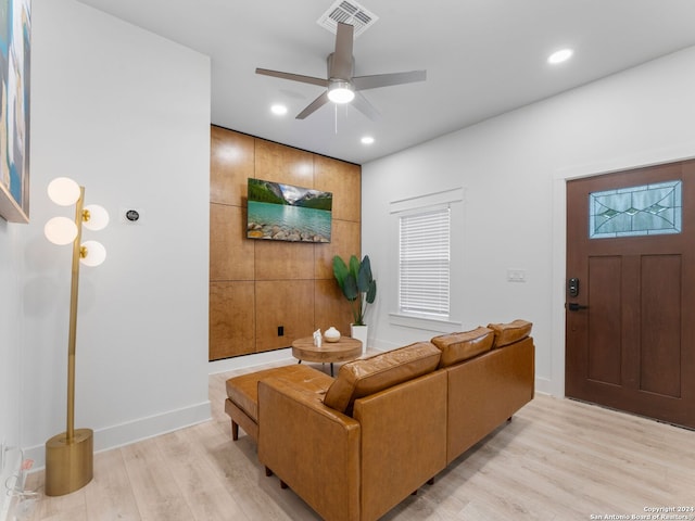 living room with ceiling fan and light hardwood / wood-style flooring