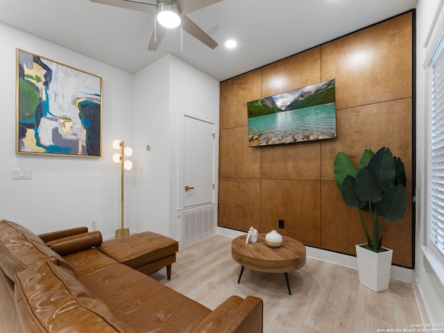 living room featuring a wealth of natural light, light hardwood / wood-style flooring, and ceiling fan