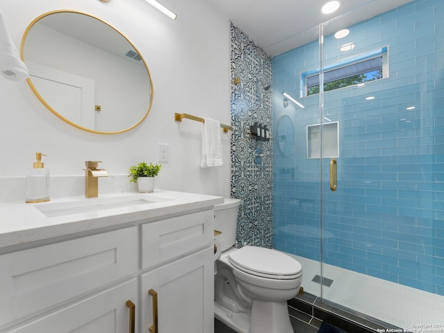 bathroom with an enclosed shower, vanity, and toilet