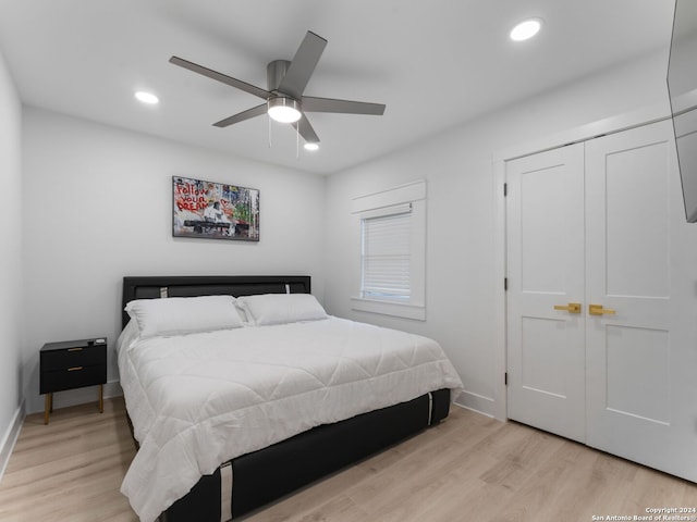 bedroom with light hardwood / wood-style flooring and ceiling fan