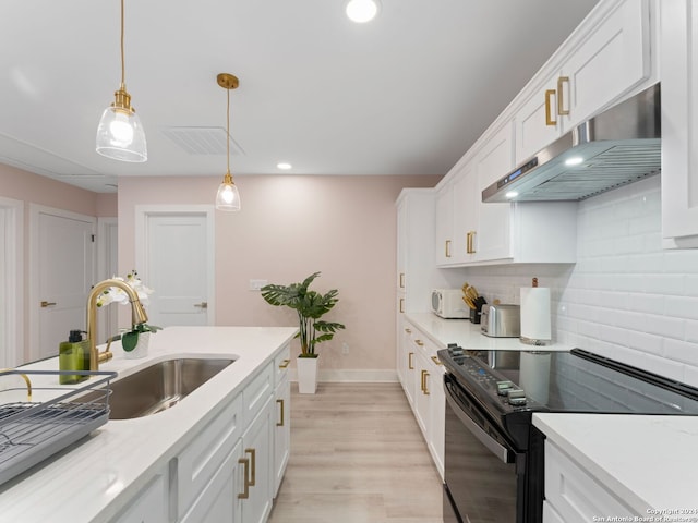 kitchen with white cabinetry, sink, tasteful backsplash, black / electric stove, and decorative light fixtures