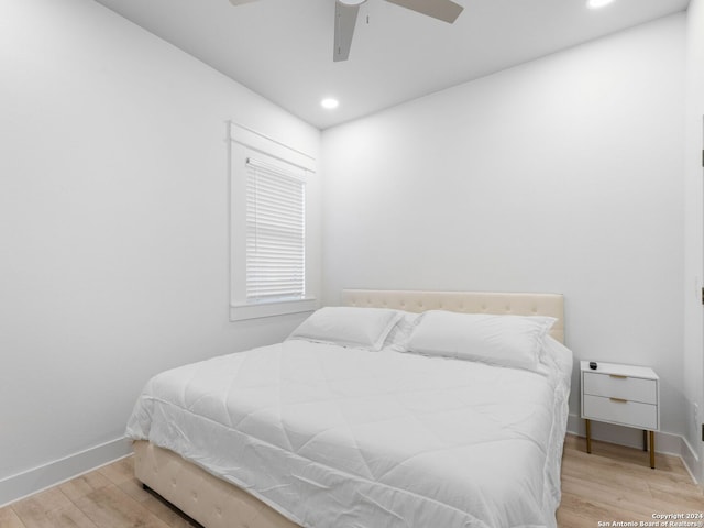 bedroom with ceiling fan and light hardwood / wood-style flooring