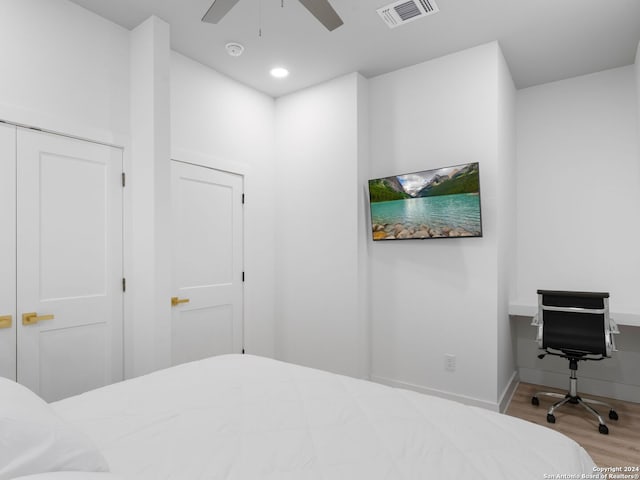 bedroom with light wood-type flooring and ceiling fan