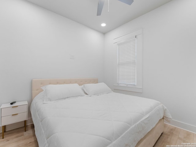 bedroom with ceiling fan and light wood-type flooring