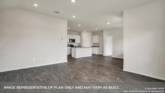 unfurnished living room with dark wood-type flooring