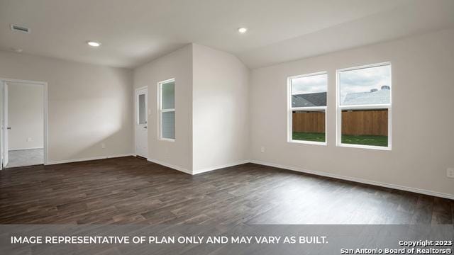 unfurnished room featuring dark wood-type flooring and vaulted ceiling