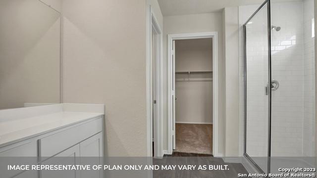 bathroom with hardwood / wood-style floors, vanity, and an enclosed shower