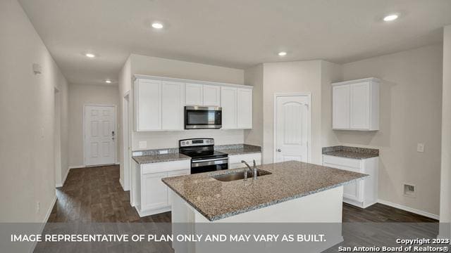 kitchen featuring white cabinets, stainless steel appliances, a kitchen island with sink, and sink