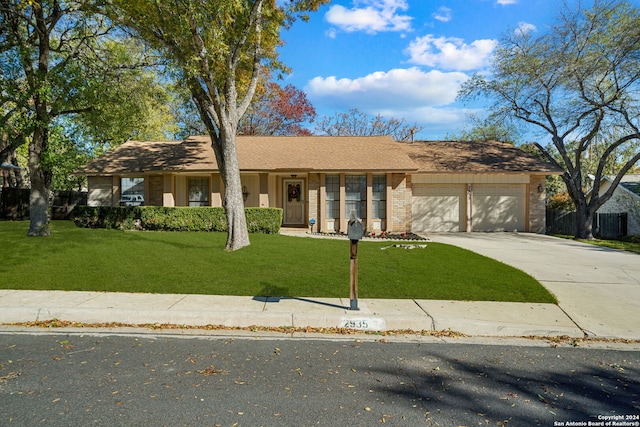 ranch-style house with a garage and a front lawn