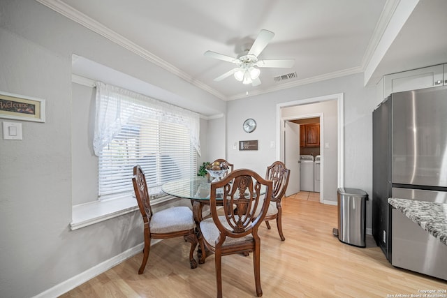 dining space with washer and dryer, ceiling fan, light wood-type flooring, and ornamental molding