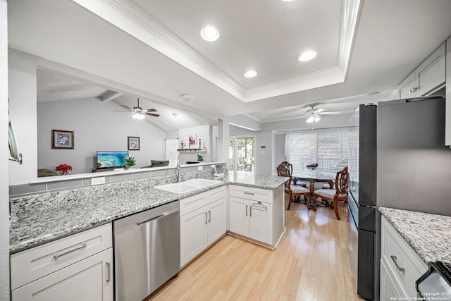 kitchen with white cabinetry, sink, lofted ceiling with beams, and appliances with stainless steel finishes