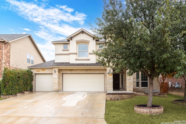 view of front of house with a garage and a front lawn