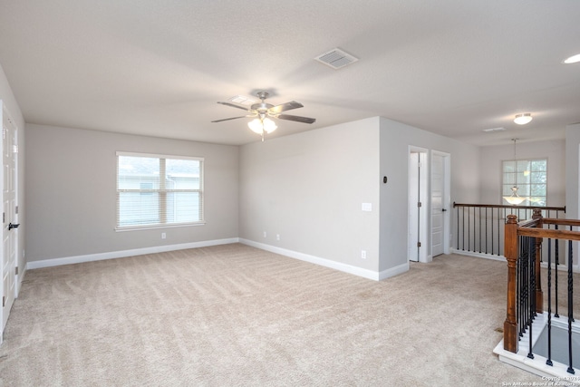 empty room with light colored carpet and ceiling fan