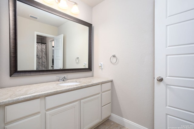 bathroom with tile patterned flooring and vanity