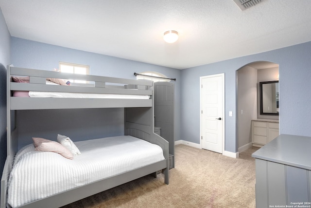 carpeted bedroom with a textured ceiling