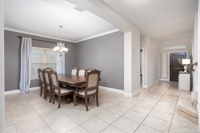 tiled dining area featuring crown molding and an inviting chandelier