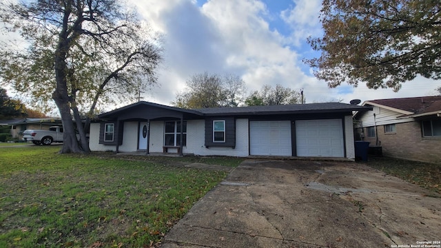 single story home with a front yard and a garage